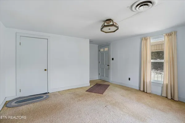 a view of an empty room with a window