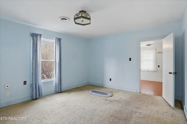a view of an empty room and a window