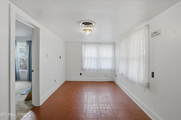 a kitchen with a sink window and cabinets