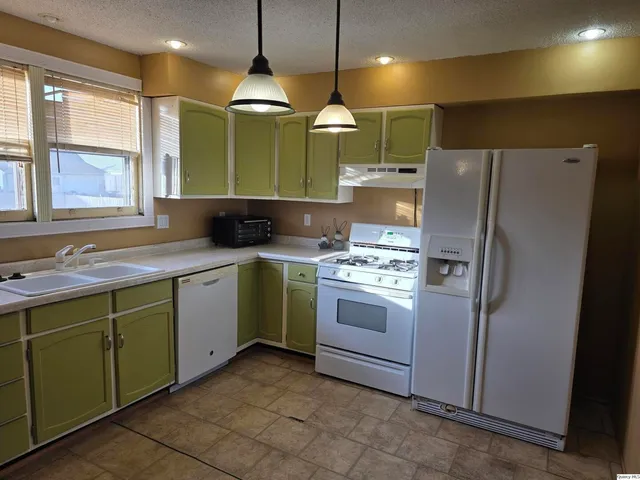 a kitchen with a sink stove and refrigerator