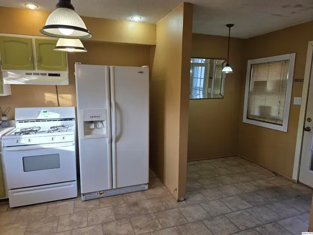 a view of a kitchen with a refrigerator and a stove