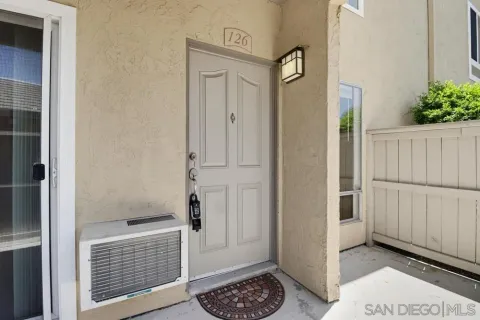a view of a hallway with entryway door
