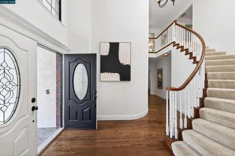 a view of entryway with wooden floor and staircase