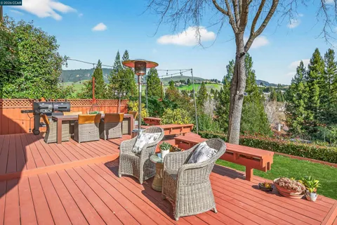 a view of a backyard with sitting area and furniture