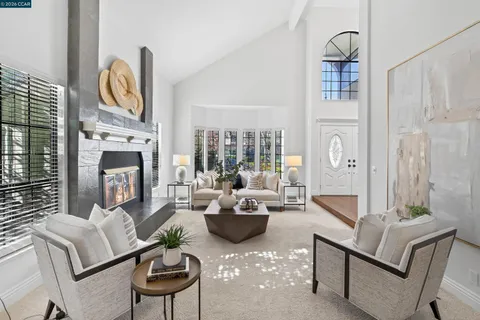 a living room with furniture a fireplace and decor