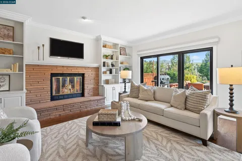 a living room with furniture fireplace and flat screen tv