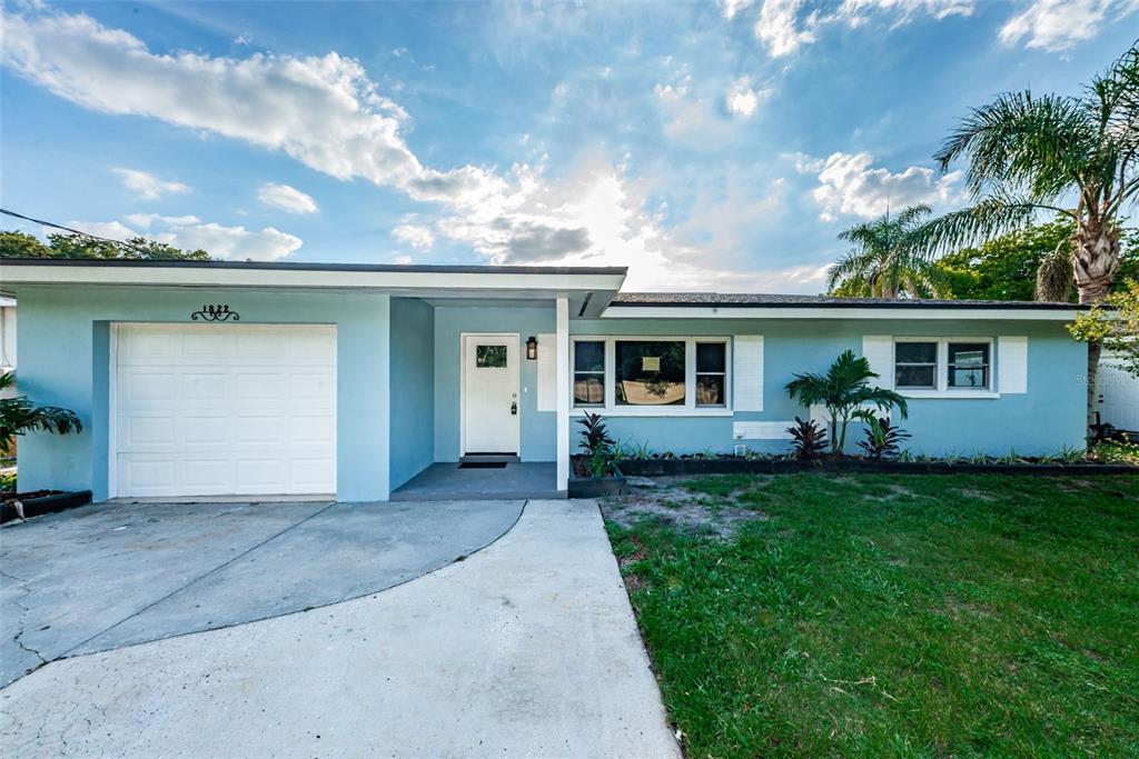 1822 Pinehurst Road Dunedin, FL 34698 - Photo 1 of 1 a front view of a house with a garden