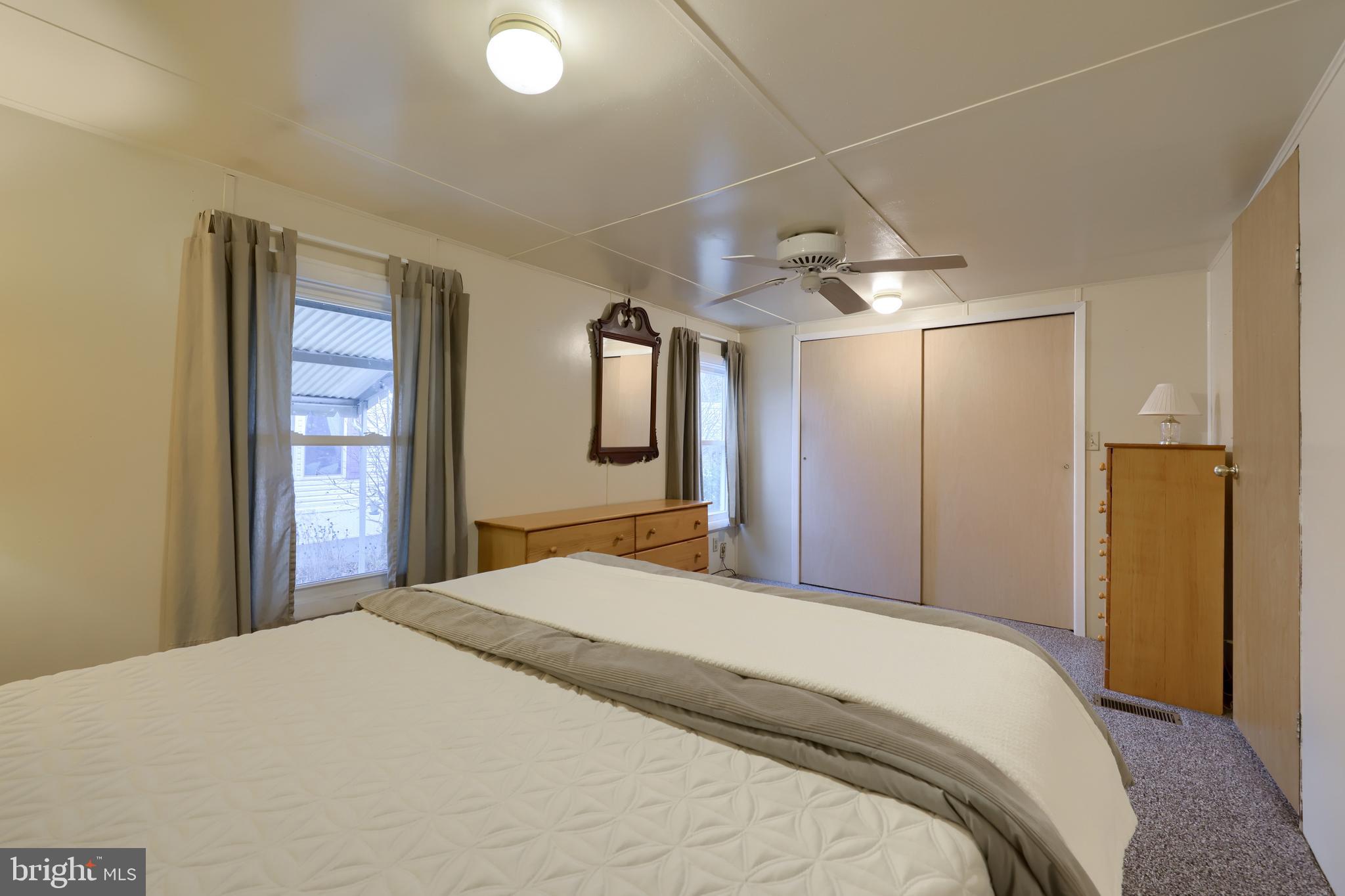 123 Ridgewood Manor Manheim, PA 17545 - Photo 21 of 25 a bedroom with a large bed and a chandelier