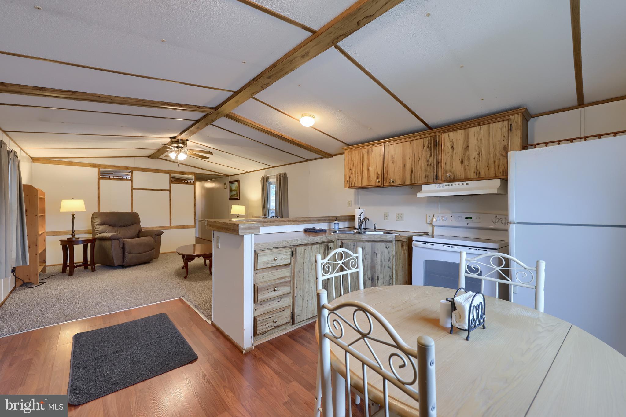 123 Ridgewood Manor Manheim, PA 17545 - Photo 7 of 25 a kitchen with stainless steel appliances granite countertop a sink dishwasher stove and refrigerator with wooden floor