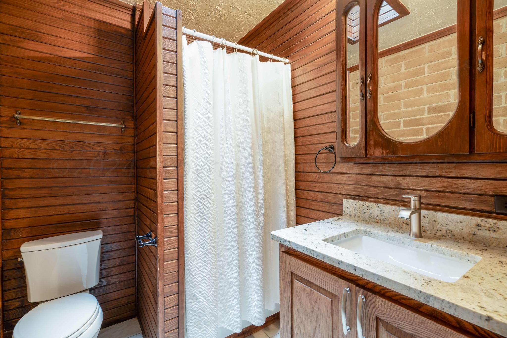 11601 East View Drive Amarillo, TX 79124 - Photo 11 of 20 a bathroom with a granite countertop sink and a toilet