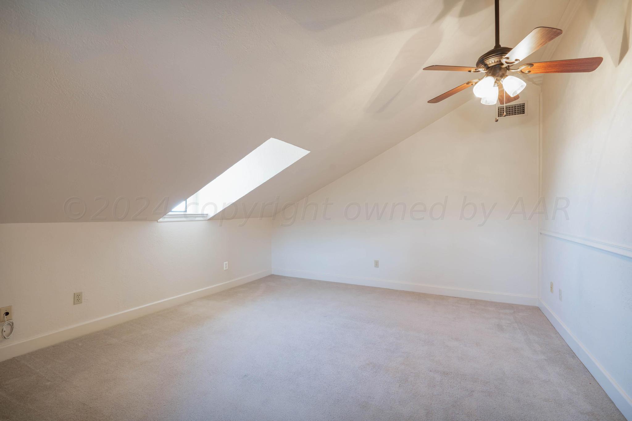 11601 East View Drive Amarillo, TX 79124 - Photo 17 of 20 an empty room with a chandelier fan and windows