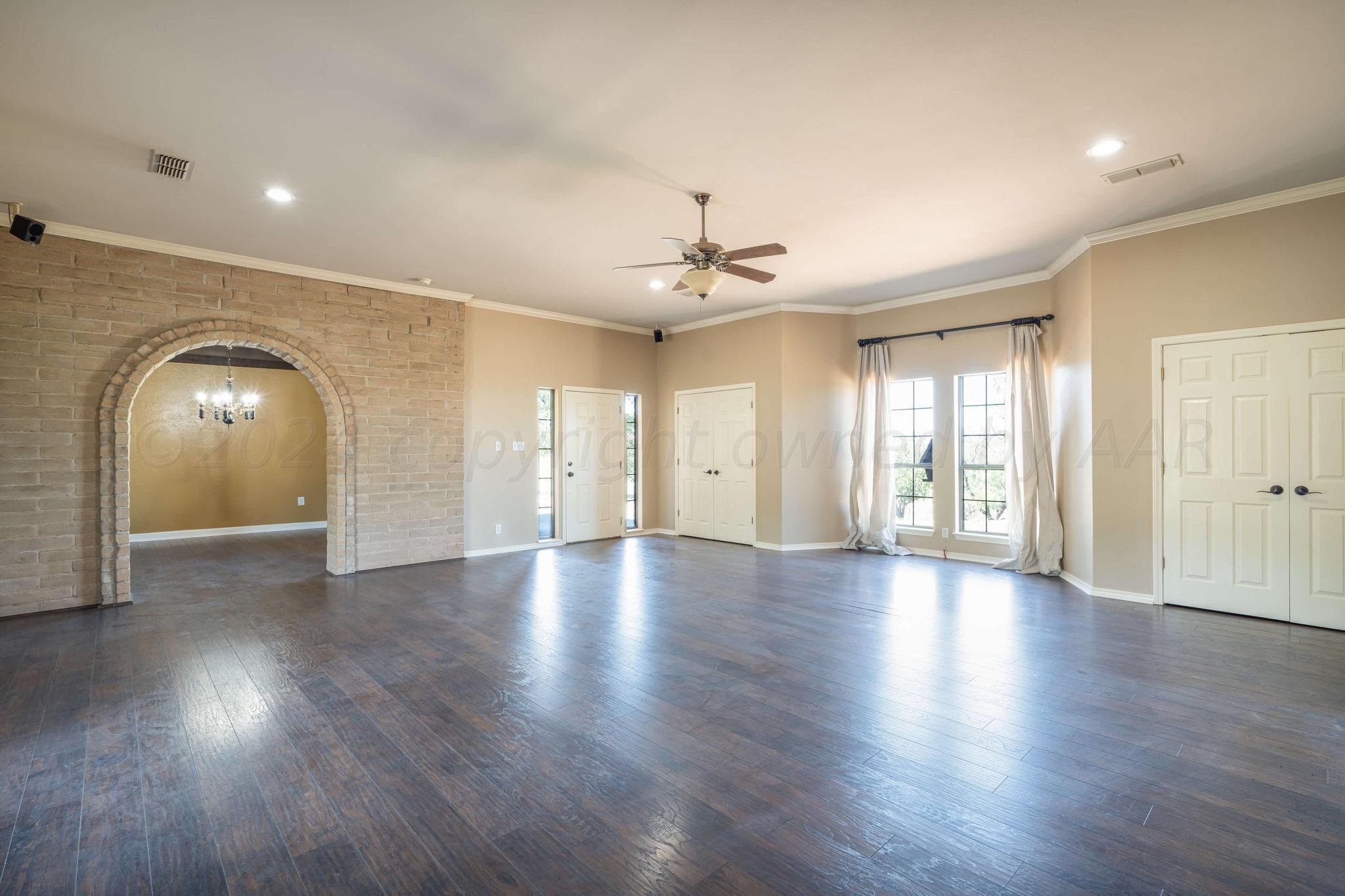 11601 East View Drive Amarillo, TX 79124 - Photo 6 of 20 a view of an empty room with wooden floor and a window