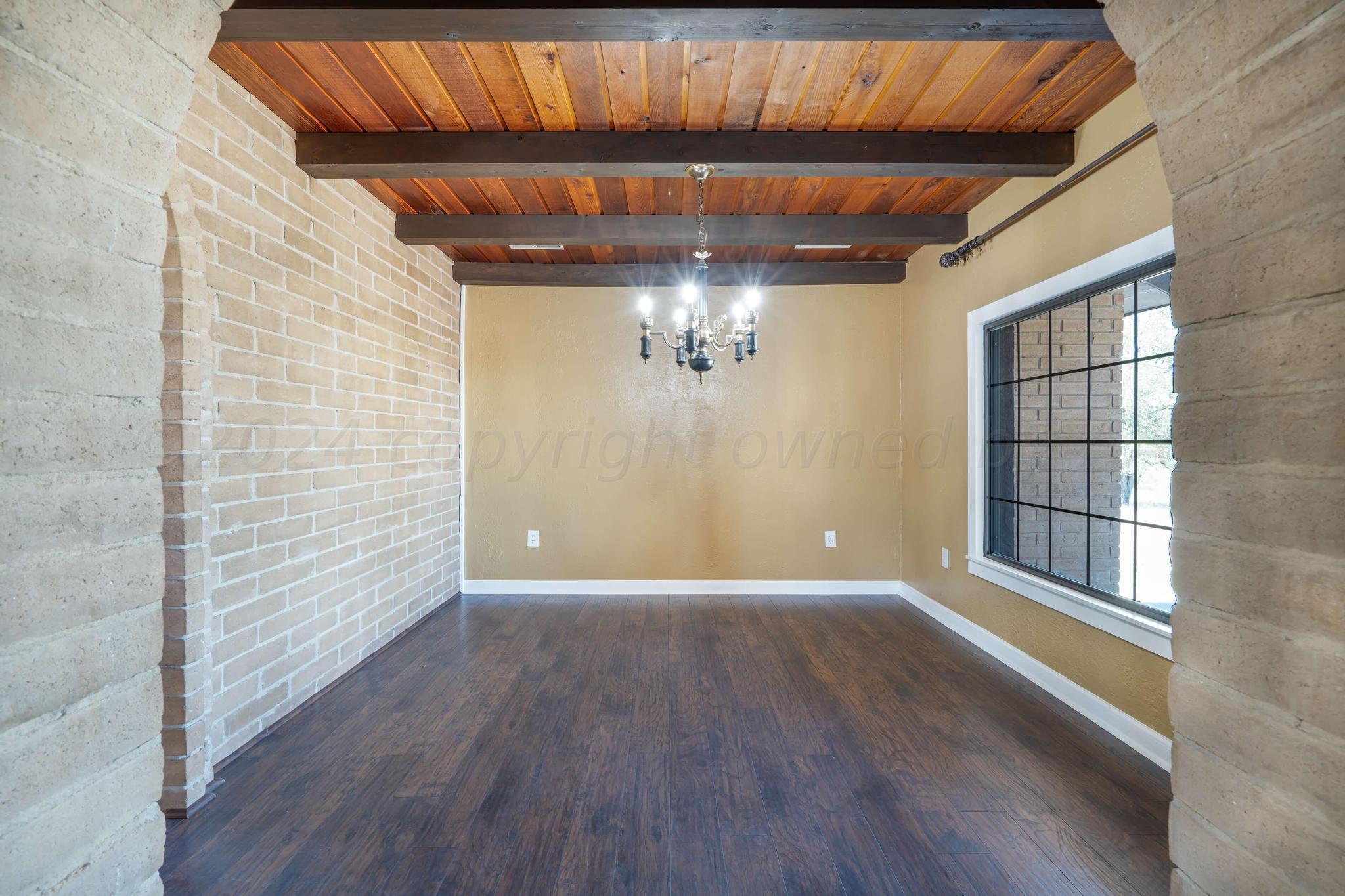 11601 East View Drive Amarillo, TX 79124 - Photo 7 of 20 an empty room with wooden floor and windows