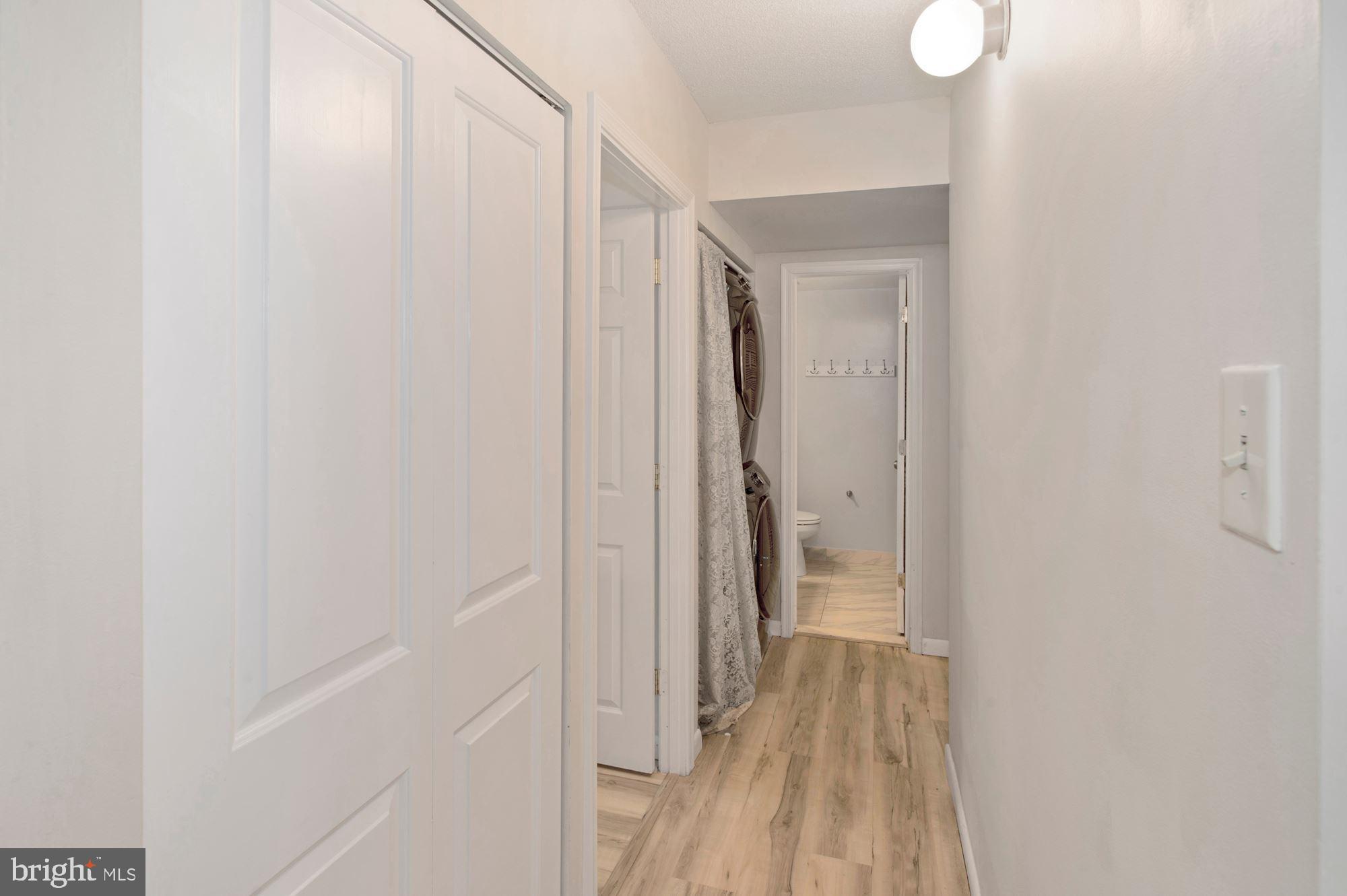 2228 Castle Rock Square, Unit 1B Reston, VA 20191 - Photo 10 of 21 Hallway to bedrooms with pantry & laundry closet