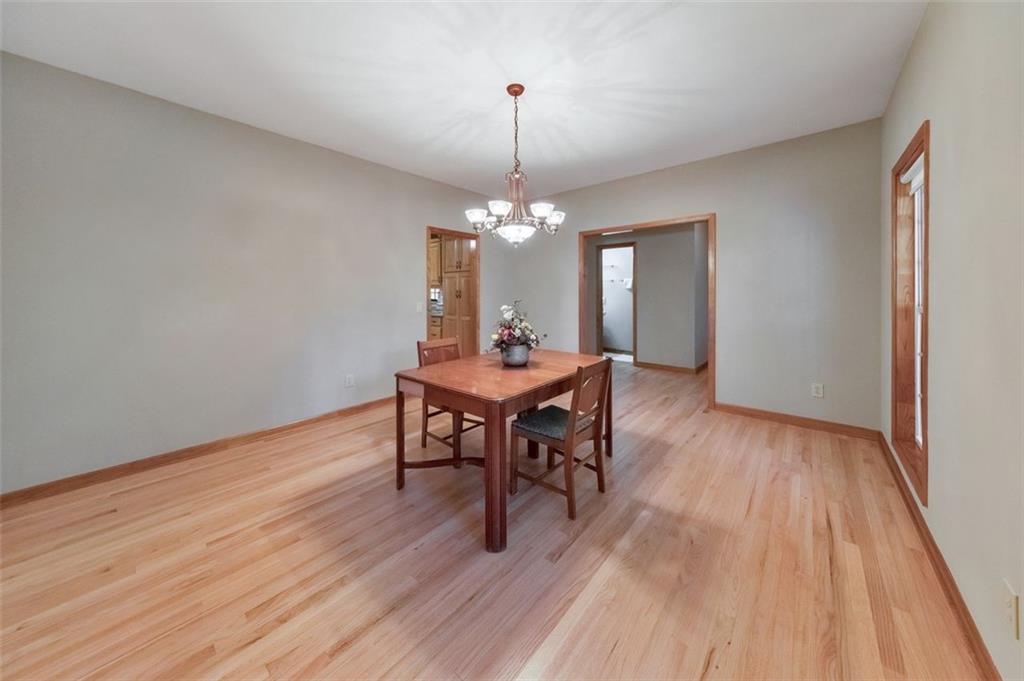 5940 Old Stilesboro Road Northwest Acworth, GA 30101 - Photo 17 of 61 a dining room with wooden floor a chandelier a wooden table and chairs