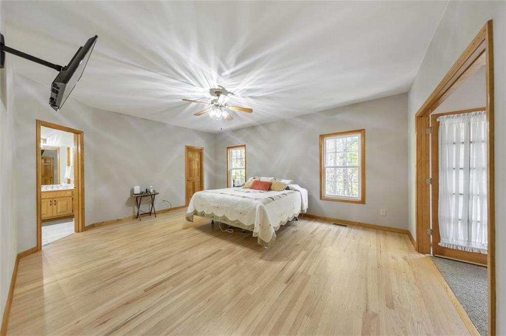 5940 Old Stilesboro Road Northwest Acworth, GA 30101 - Photo 29 of 61 a spacious bedroom with a bed and a chandelier