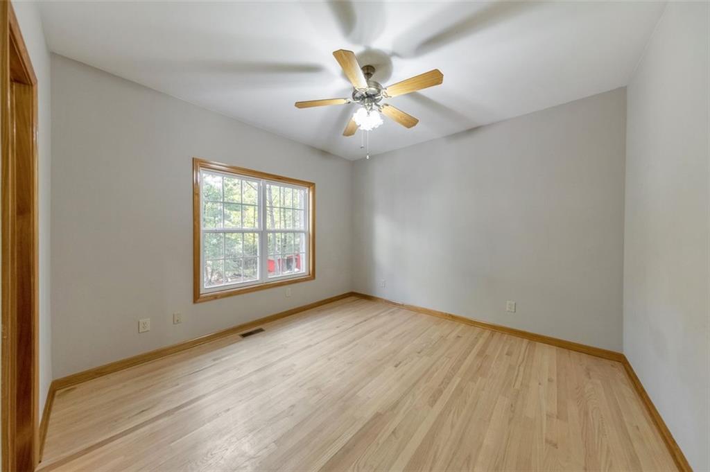 5940 Old Stilesboro Road Northwest Acworth, GA 30101 - Photo 36 of 61 an empty room with wooden floor fan and windows
