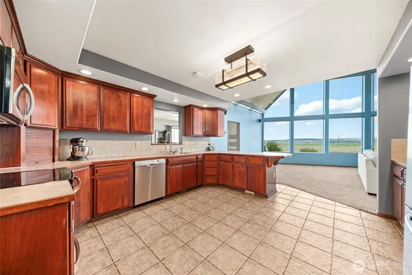 a kitchen with stainless steel appliances granite countertop a sink and cabinets