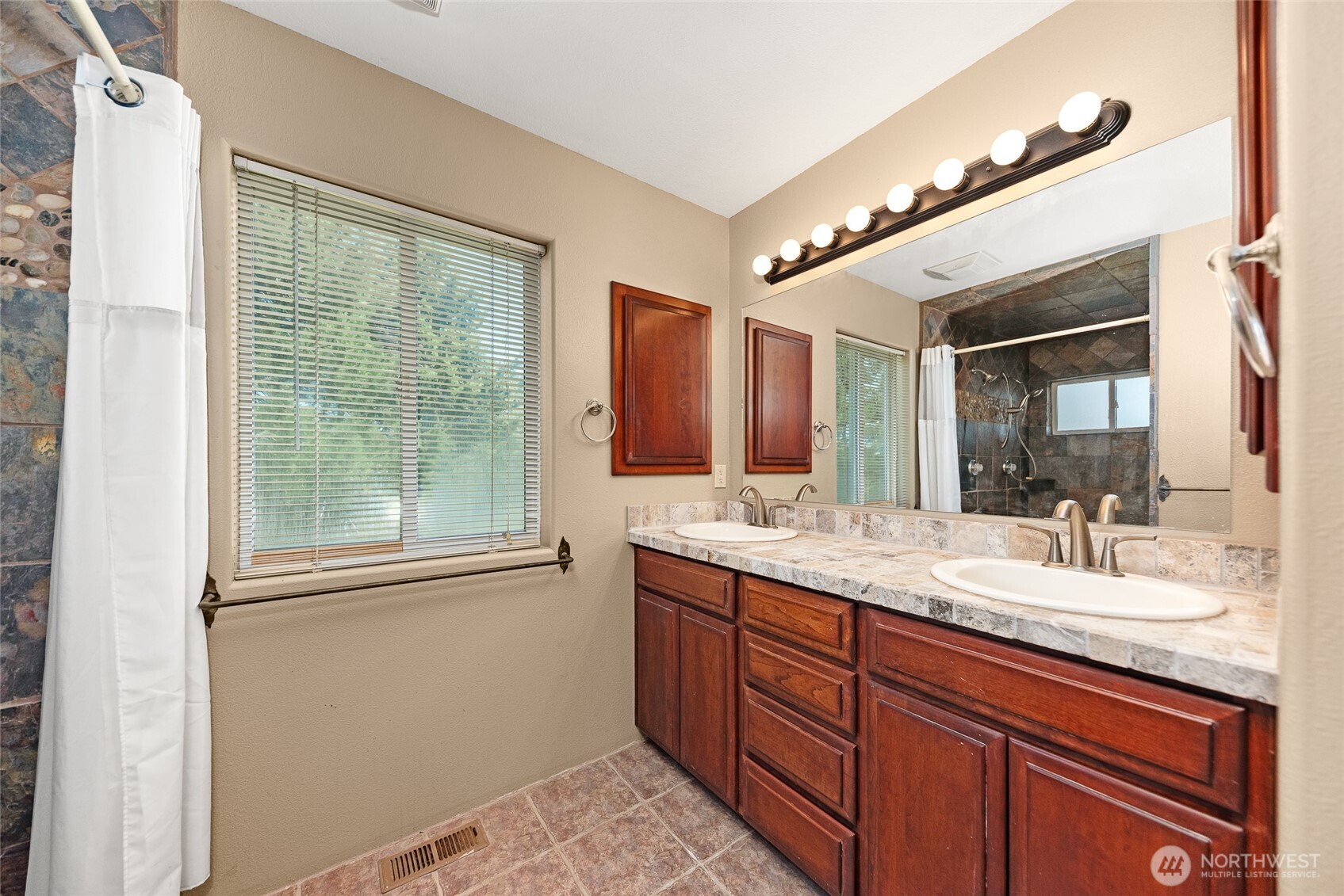 37761 L-NE Road Hartline, WA 99135 - Photo 18 of 40 a bathroom with a granite countertop sink a large mirror and a shower