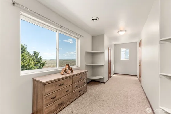 a room with a bed and a large window