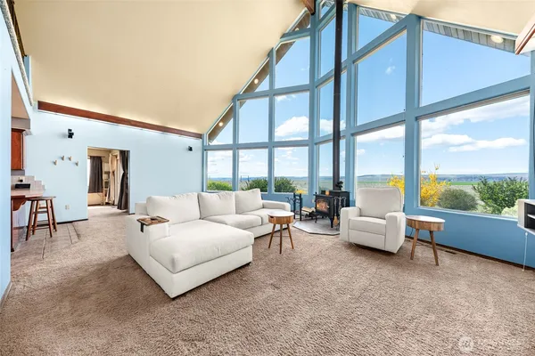 a living room with furniture and large windows