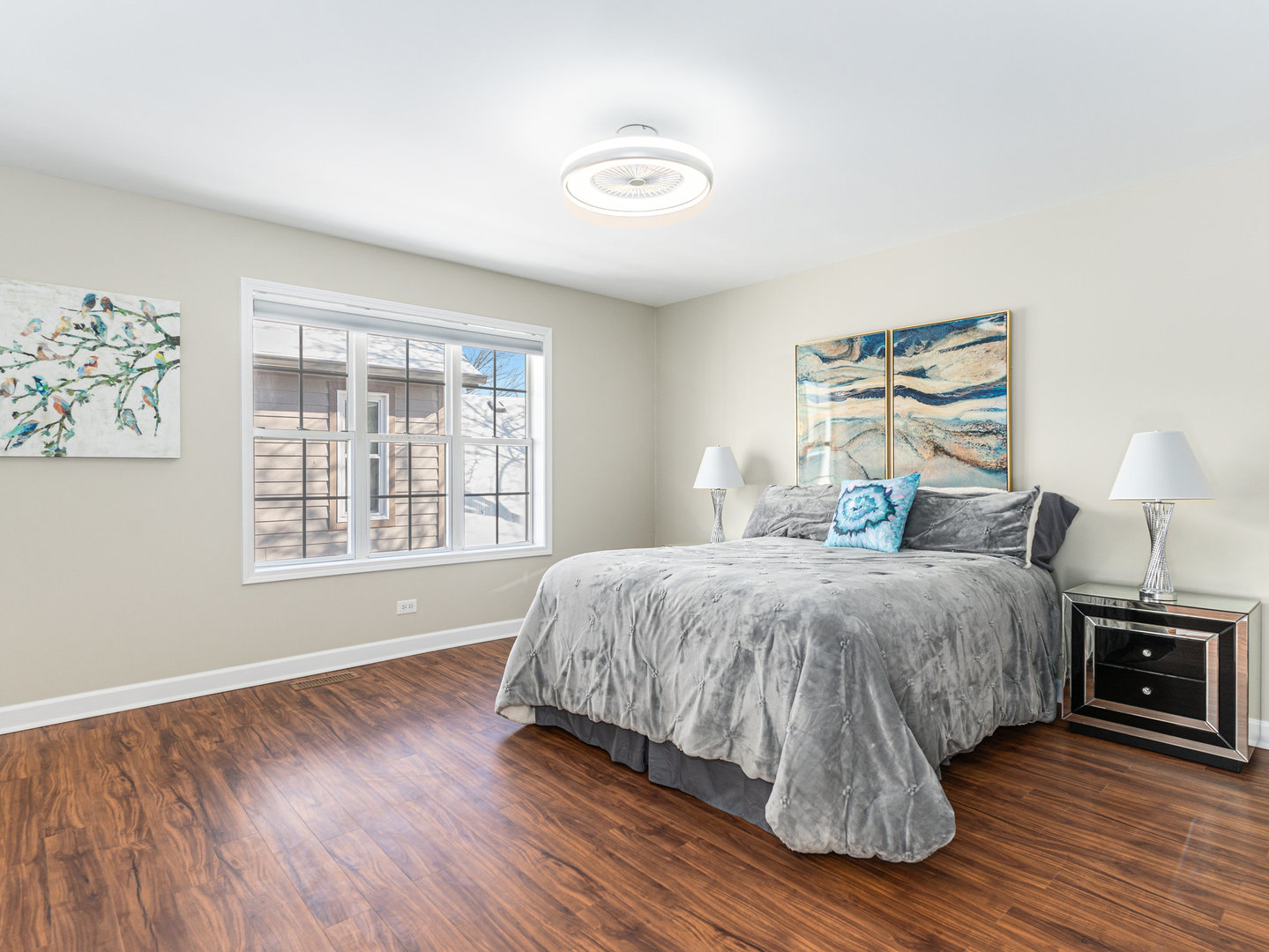 23024 Pilcher Road Plainfield, IL 60544 - Photo 28 of 56 a spacious bedroom with a bed a dresser and wooden floor