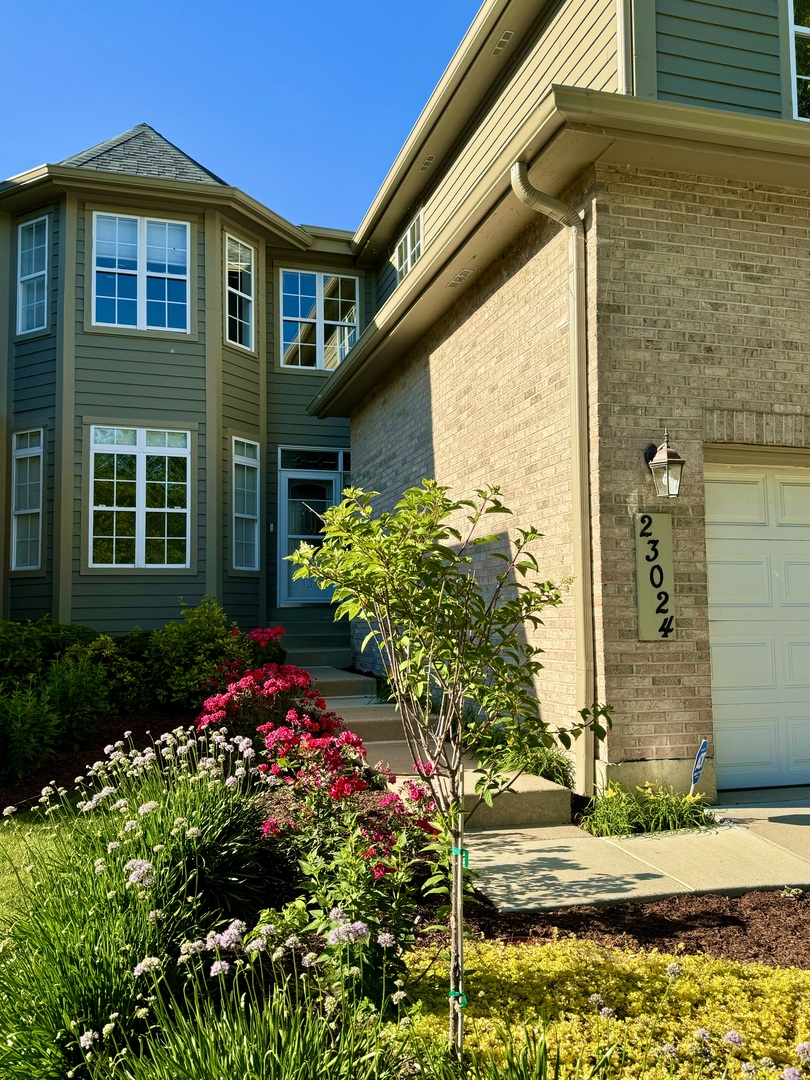 23024 Pilcher Road Plainfield, IL 60544 - Photo 39 of 56 a front view of a house with a yard