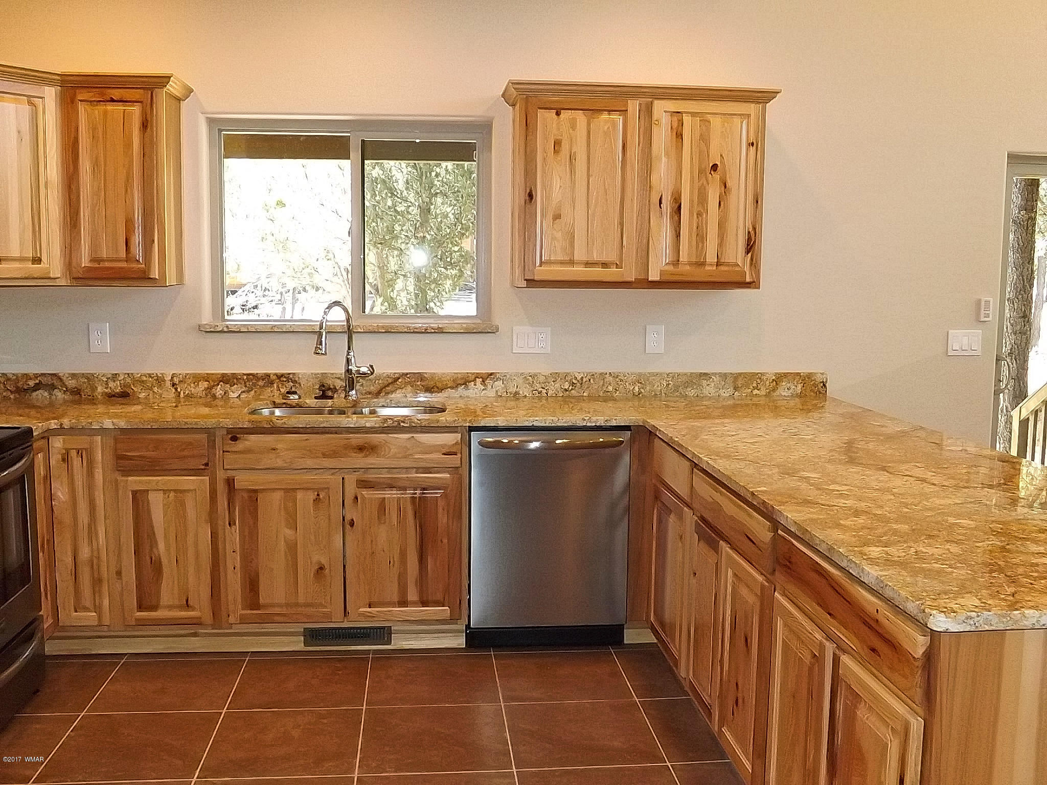 2967 Monica Road Overgaard, AZ 85933 - Photo 15 of 38 a kitchen with stainless steel appliances granite countertop a stove a sink and a microwave