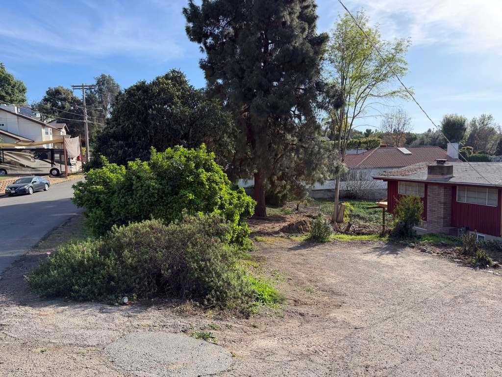 3536 Ybarra Road Spring Valley, CA 91978 - Photo 8 of 42 a view of a street with potted plants and large trees