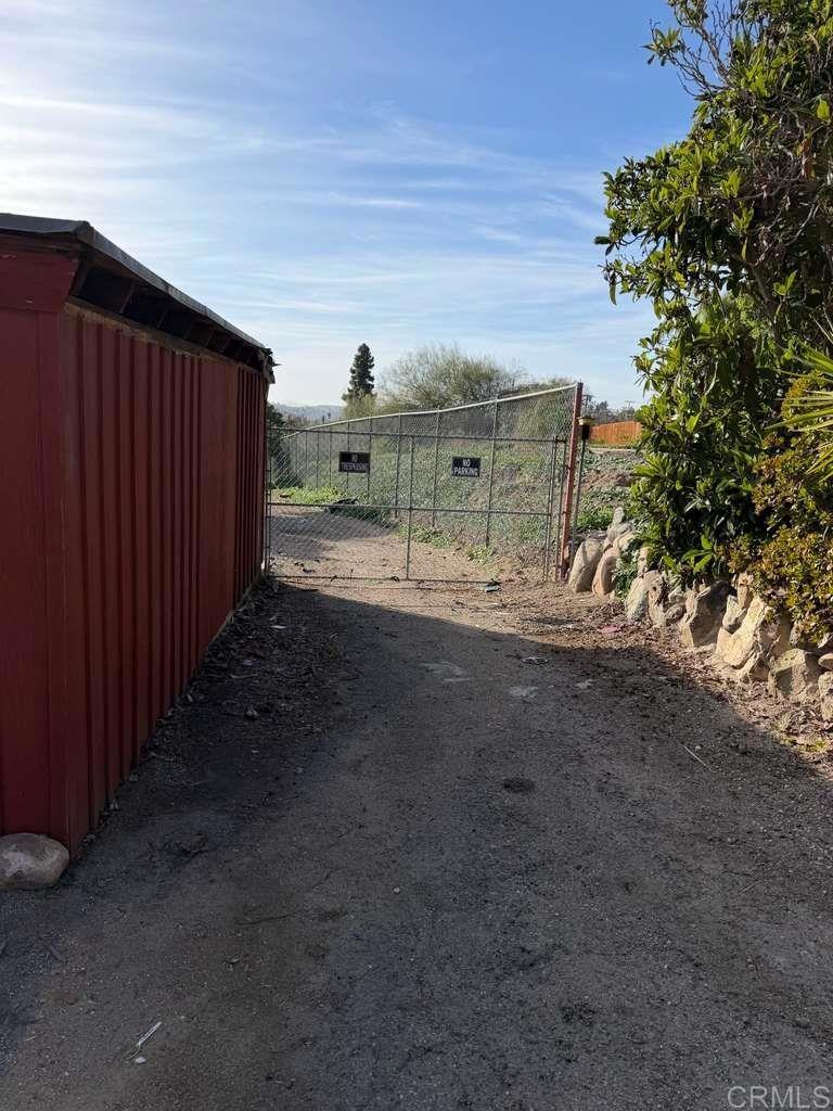 3536 Ybarra Road Spring Valley, CA 91978 - Photo 9 of 42 a view of a dirt road with wooden fence