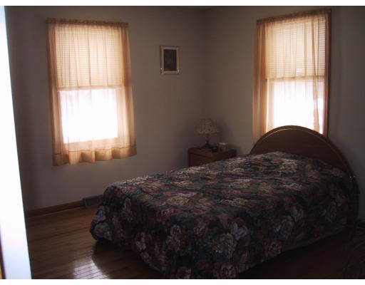 76 Vann Street Springfield, MA 01119 - Photo 5 of 6 a bedroom with a bed window and lamp