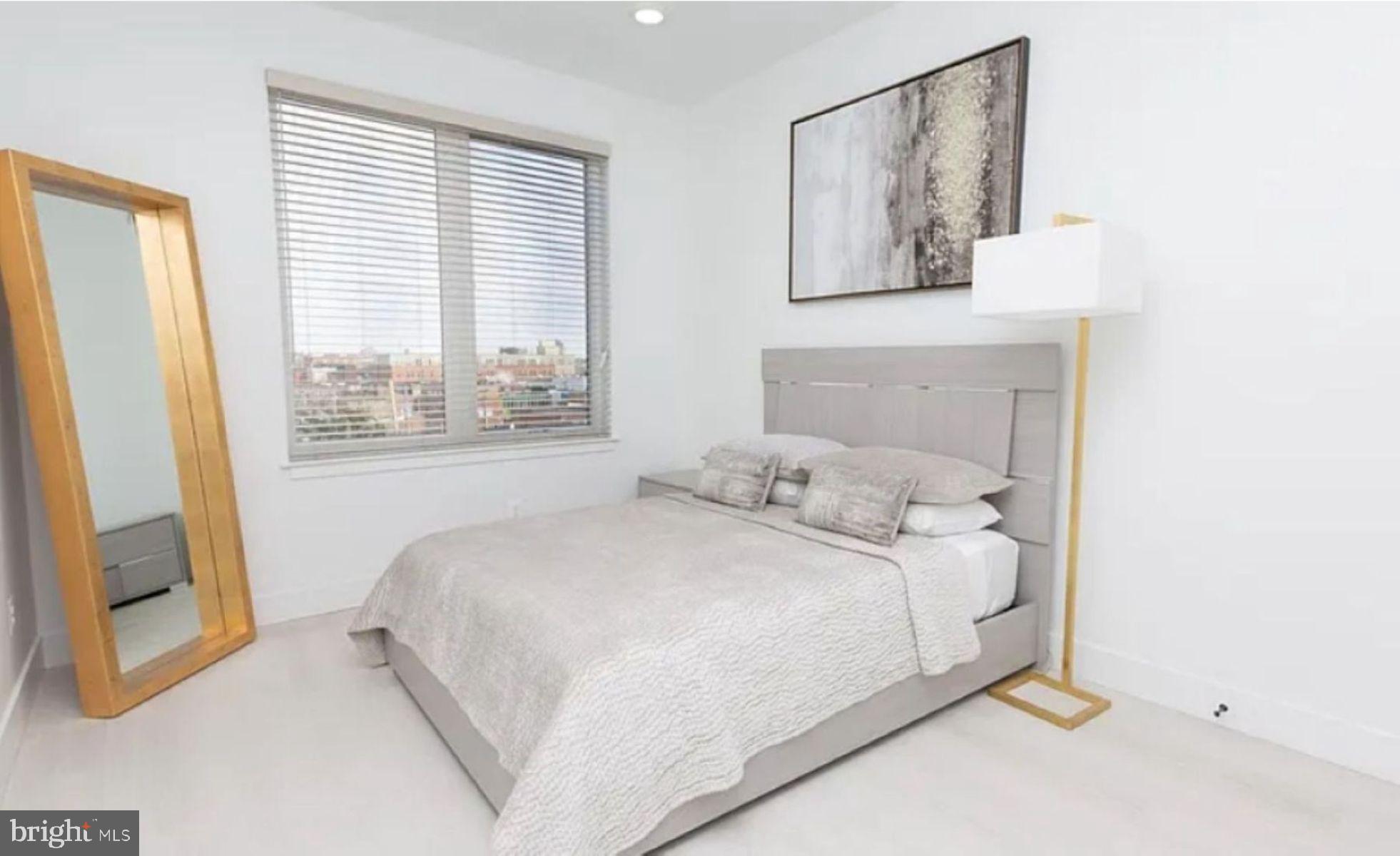 520 South Caroline Street, Unit 405 Baltimore, MD 21231 - Photo 7 of 18 a bedroom with a bed and a large window