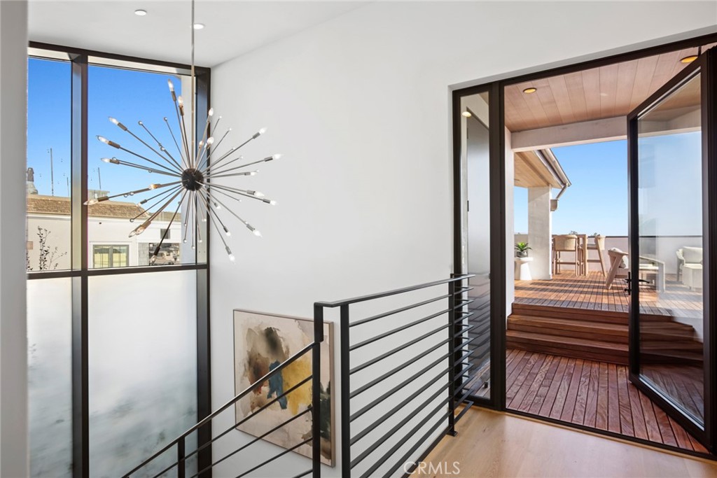 304 Poppy Avenue Corona del Mar, CA 92625 - Photo 26 of 35 a view of a hallway with wooden floor and staircase