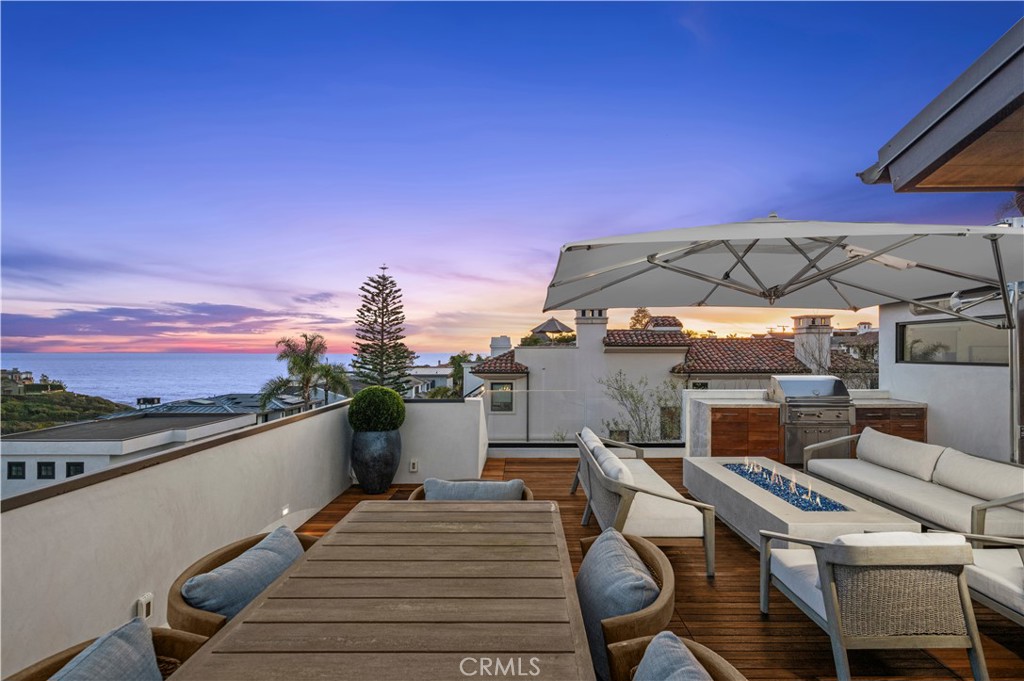 304 Poppy Avenue Corona del Mar, CA 92625 - Photo 32 of 35 a view of a balcony with two chairs and a barbeque