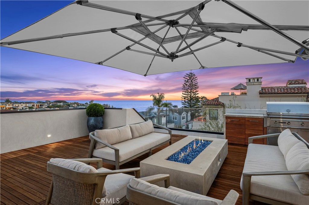 304 Poppy Avenue Corona del Mar, CA 92625 - Photo 4 of 35 a view of a balcony with furniture and a umbrella