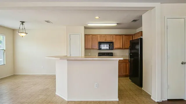 a kitchen with refrigerator and window