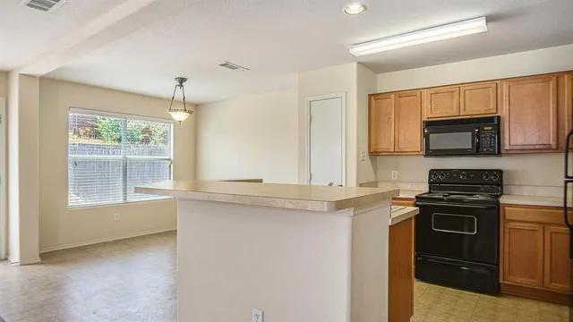 a kitchen with a stove a sink and a microwave