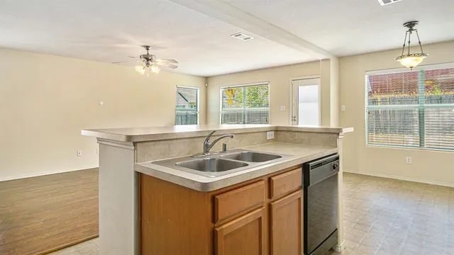 a kitchen with stainless steel appliances granite countertop a sink a stove and a refrigerator
