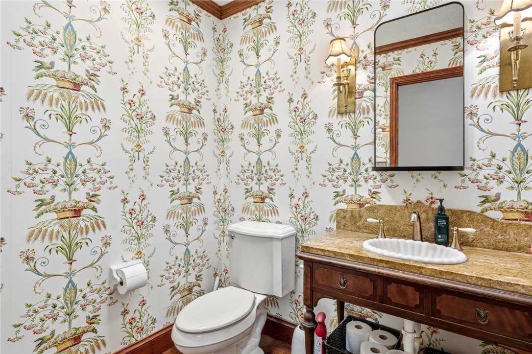 10168 Atchison Road Dayton, OH 45458 - Photo 28 of 44 This charming powder room features elegant wallpaper and a classic vanity with a stylish mirror.