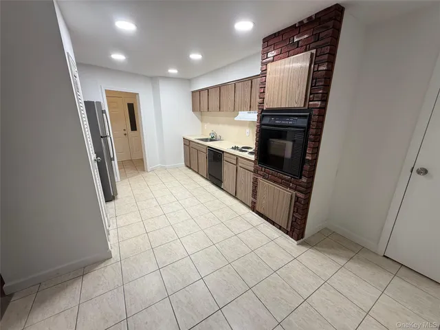 a kitchen with stainless steel appliances a refrigerator and a sink