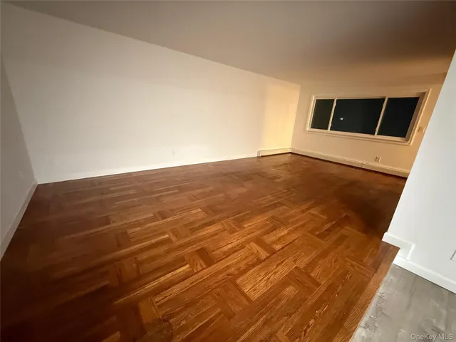 a view of a livingroom with wooden floor and a flat screen tv