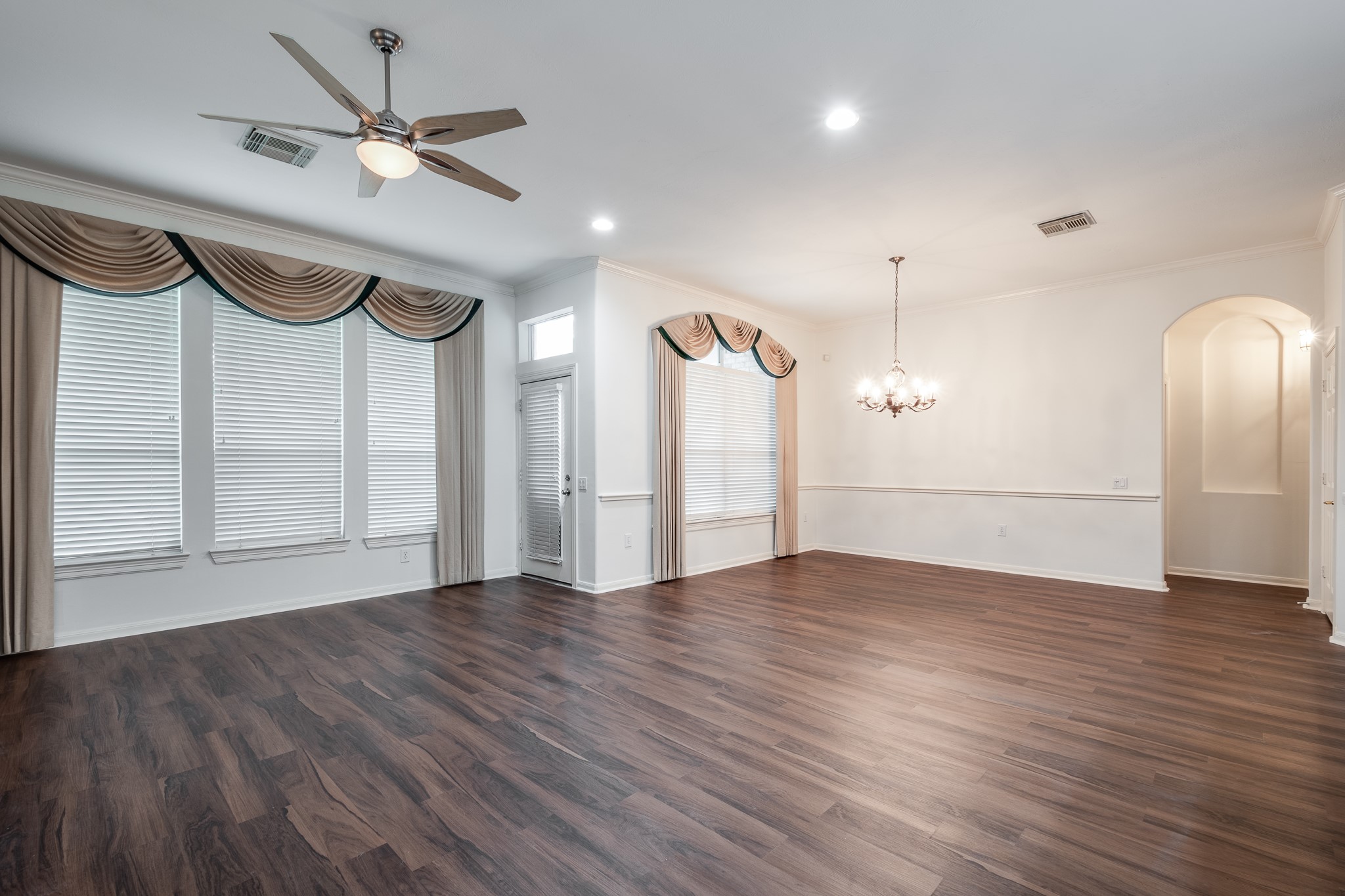 43 North Belfair Place Spring, TX 77382 - Photo 11 of 36 an empty room with wooden floor ceiling fan and windows
