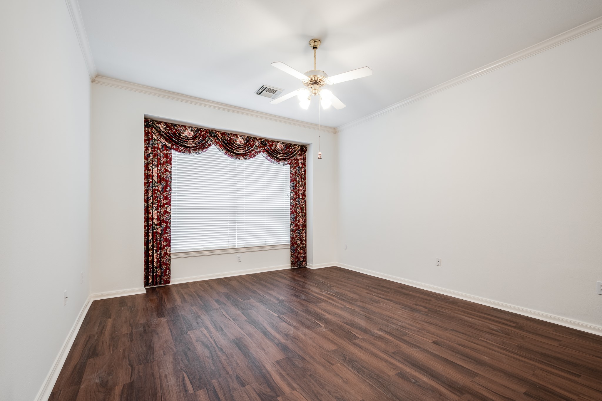 43 North Belfair Place Spring, TX 77382 - Photo 18 of 36 a view of an empty room with wooden floor and a window