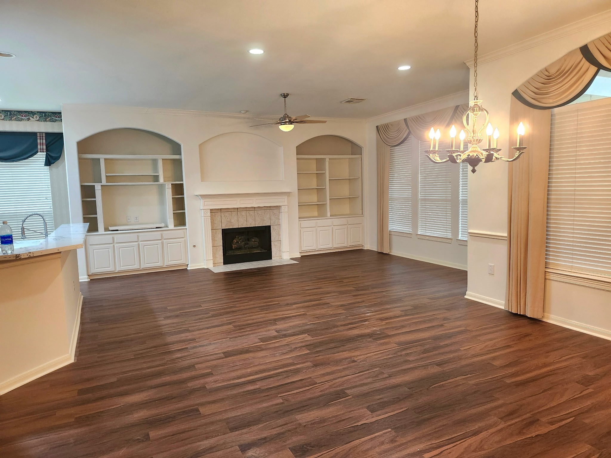 43 North Belfair Place Spring, TX 77382 - Photo 9 of 36 a view of a livingroom with a fireplace wooden floor and chandelier
