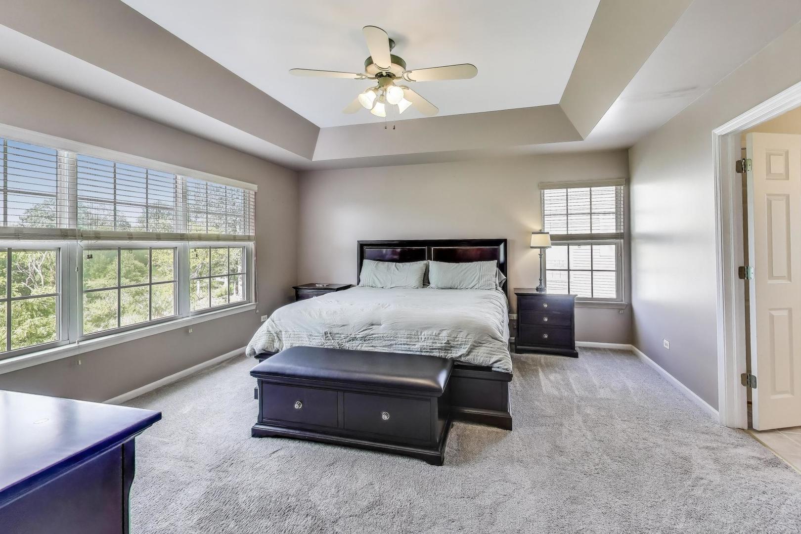 17119 West Prairieview Lane Gurnee, IL 60031 - Photo 17 of 40 a spacious bedroom with a bed and a large window
