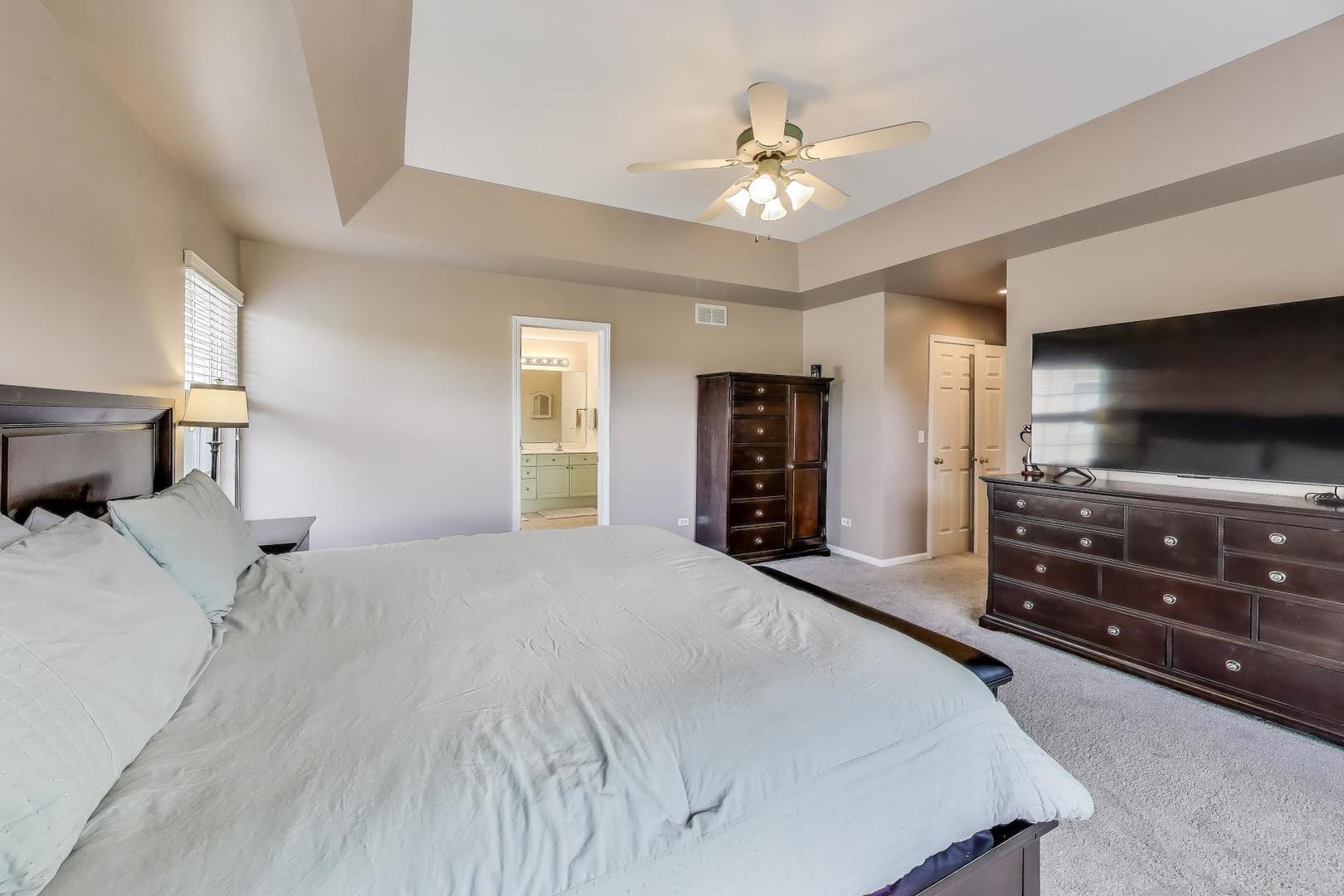 17119 West Prairieview Lane Gurnee, IL 60031 - Photo 19 of 40 a bedroom with a bed and a flat screen tv