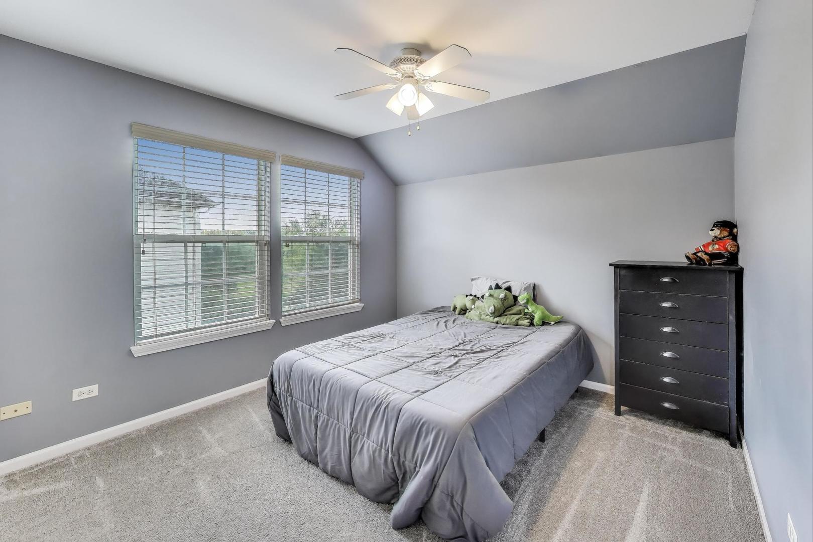 17119 West Prairieview Lane Gurnee, IL 60031 - Photo 23 of 40 a bedroom with a bed and a dresser