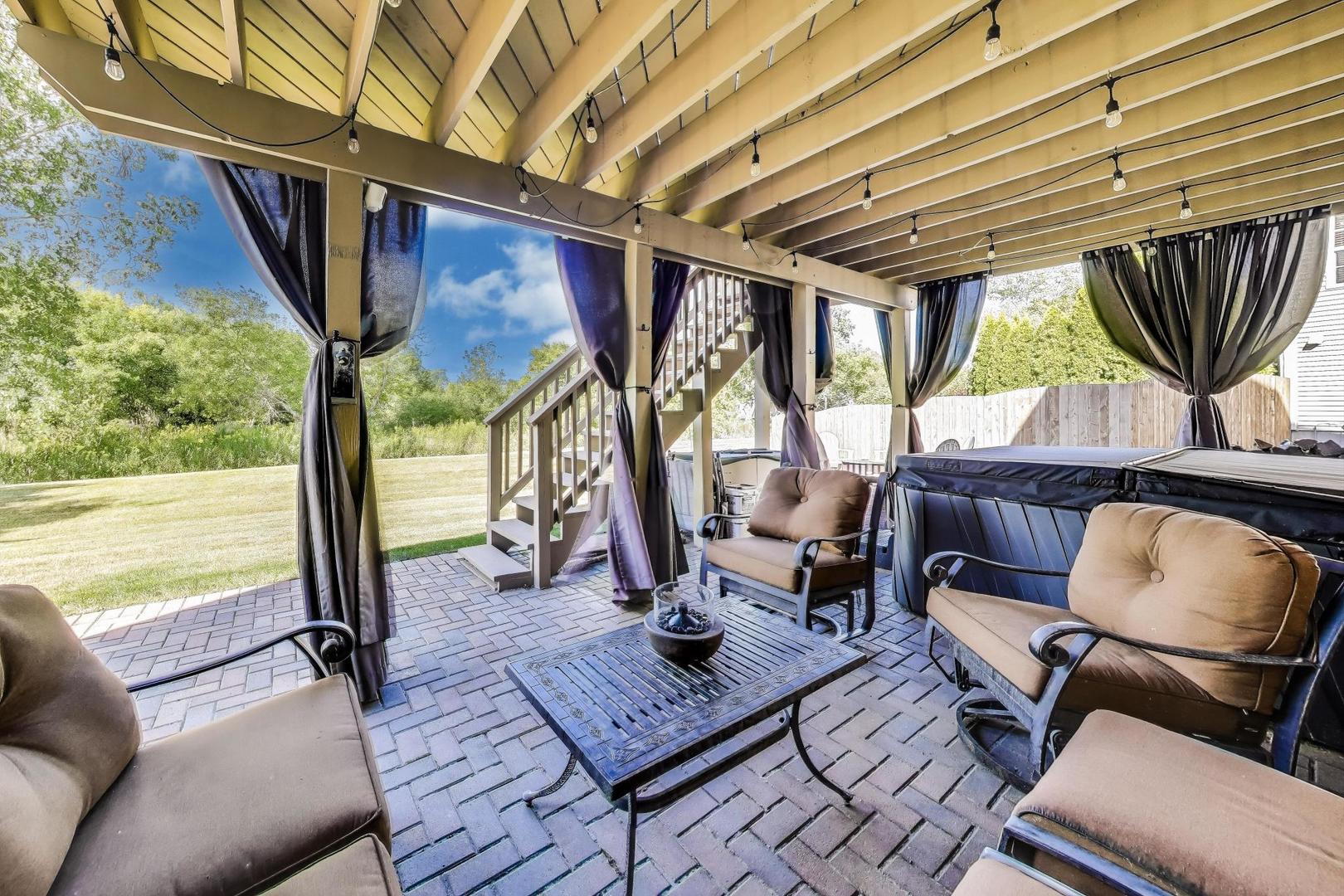17119 West Prairieview Lane Gurnee, IL 60031 - Photo 33 of 40 a living room with furniture a floor to ceiling window and wooden floor