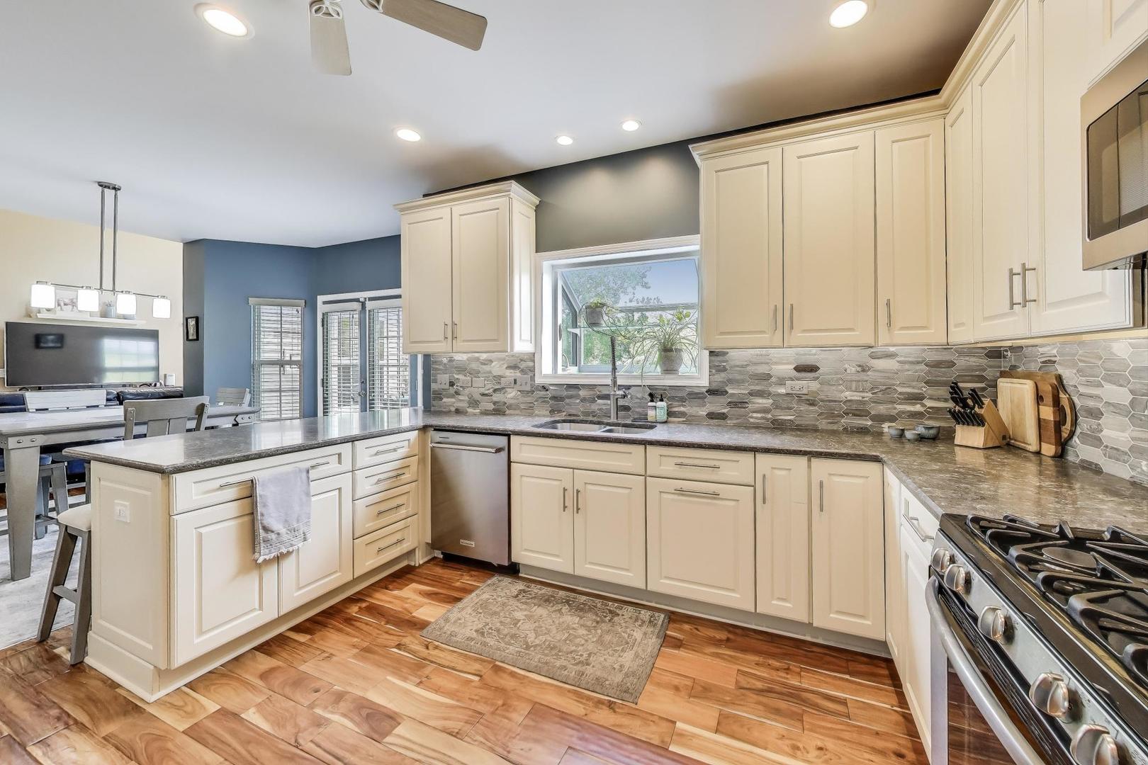 17119 West Prairieview Lane Gurnee, IL 60031 - Photo 8 of 40 a kitchen with stainless steel appliances granite countertop a stove a sink and a granite counter tops