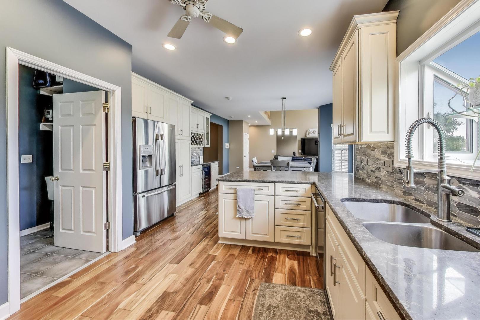 17119 West Prairieview Lane Gurnee, IL 60031 - Photo 9 of 40 a kitchen with white cabinets and stainless steel appliances